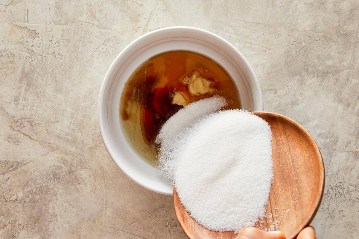 mixture of sugar, lemon, mirin seasoning, mustard, sesame oil and soy sauce in a bowl