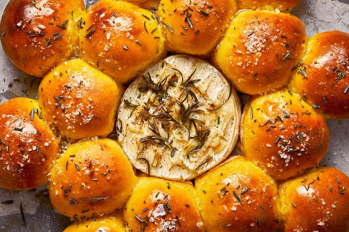 close up shot of baked camembert and freshly baked bread