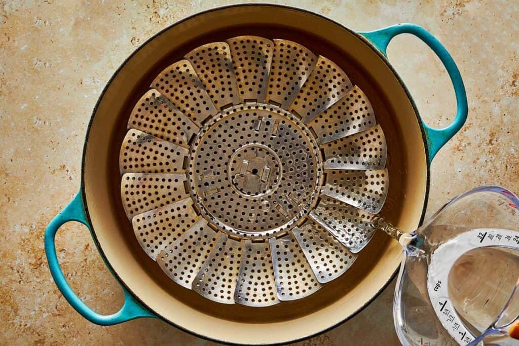 A steam pot in a teal color dutch oven