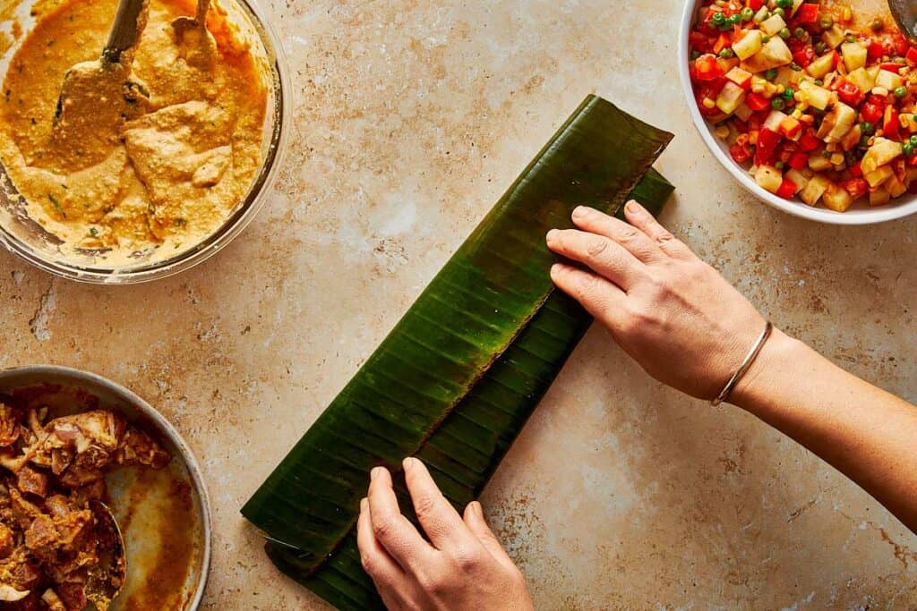 banana leaf green being wrapped by female hands