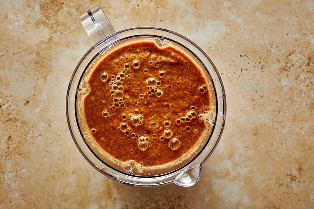top down shot of a blender jug with brown sauce inside