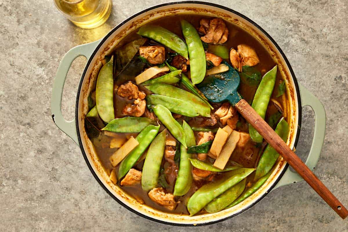 chicken stock, coconut milk, palm sugar, fish sauce, and kaffir leaves, snow peas and bamboo shoots