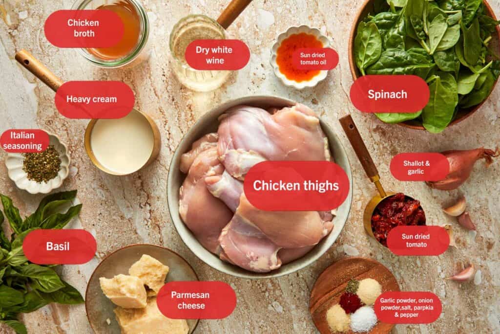 Top down shot of all the ingredients separately spaced out in bowls needed to make tuscan chicken thighs