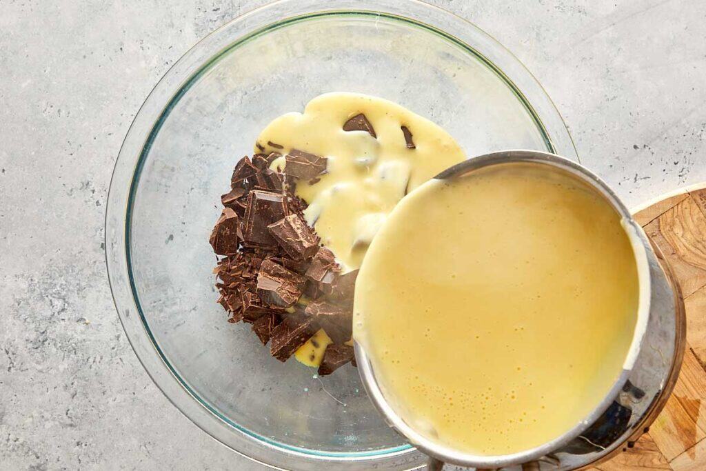 chocolate and custard mix being poured into a mixing bowl