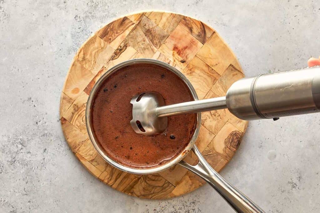 A stick mixer, mixing the chocolate together