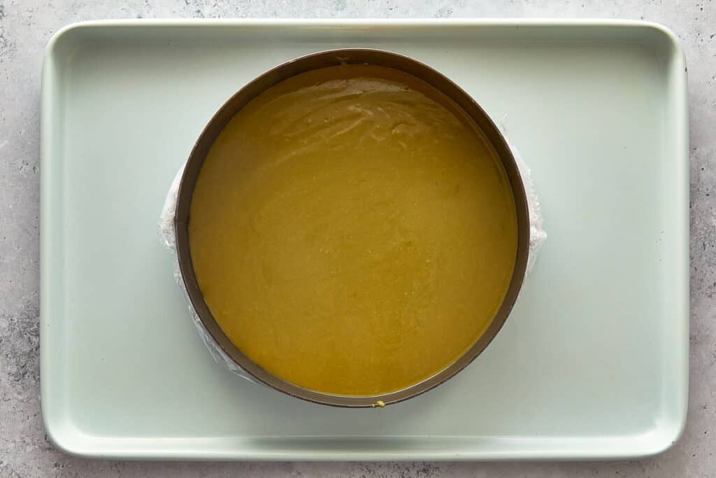 top down view of a cake ring and a base of custard ready to be placed in the fridge