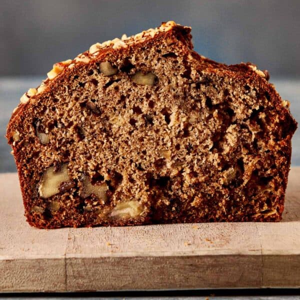 a side view of a slice of banana bread sitting on top of a board
