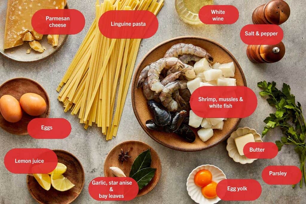 a top down shot of all the ingredients needed to make a creamy pasta seafood dish - 2