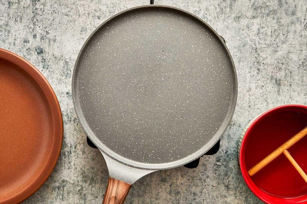 a top down view of a kitchen bench and a crepe pan sitting on top - 14
