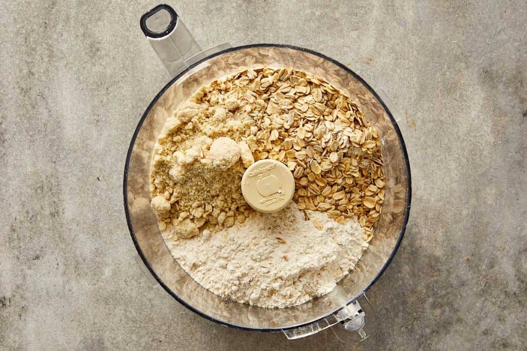 a top down photo of a food processor with dry ingredients in it ready for blending - 4