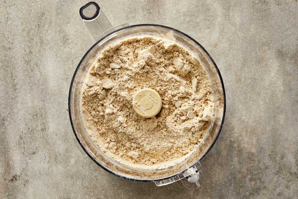 a top down photo of a food processor with dry ingredients that have been blended - 5