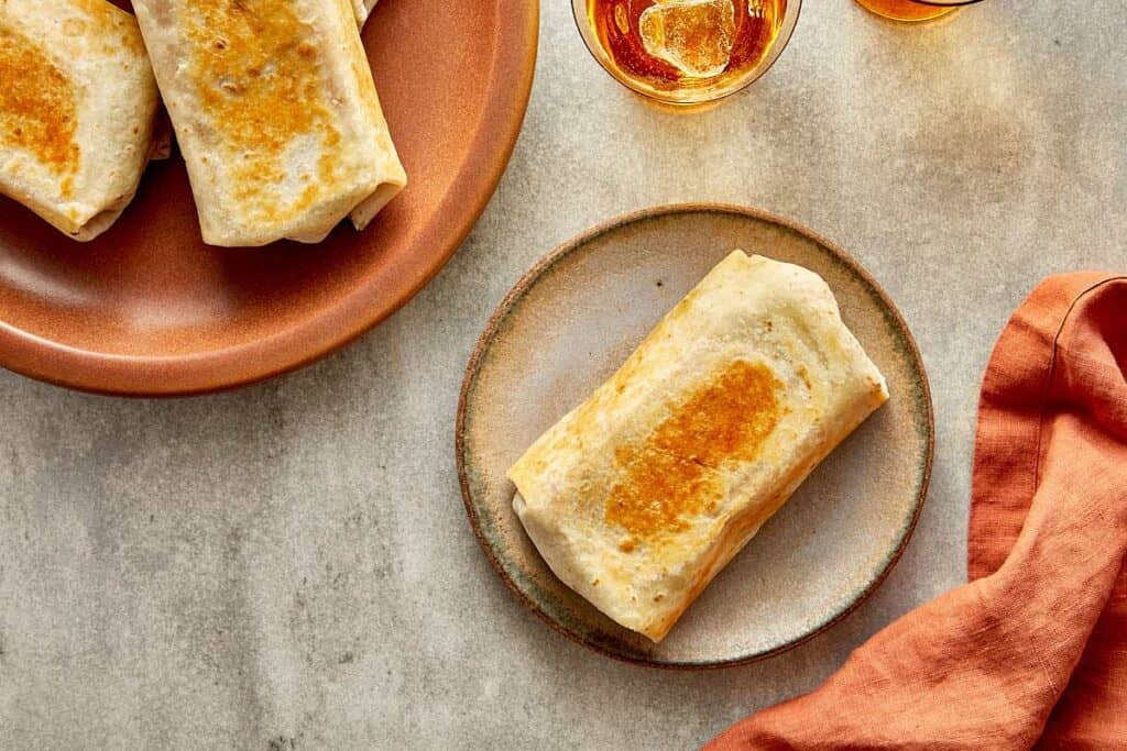 a top down view of a plate of wraps toasted and a single wrap toasted - 18