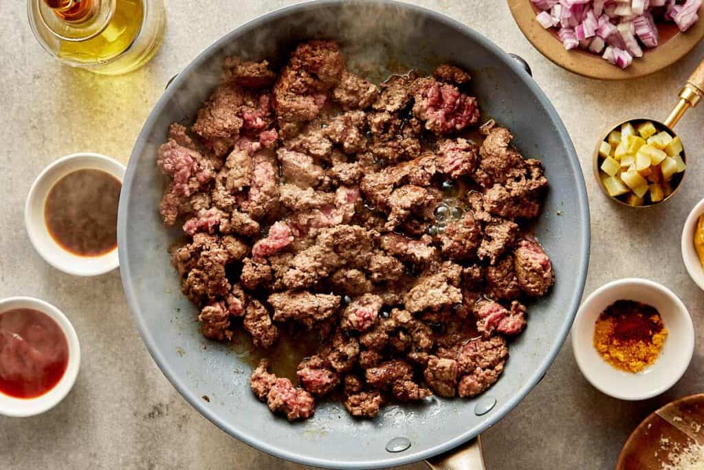 a top down view of a pan filled with mince meat being cooked on a benchtop stove - 5