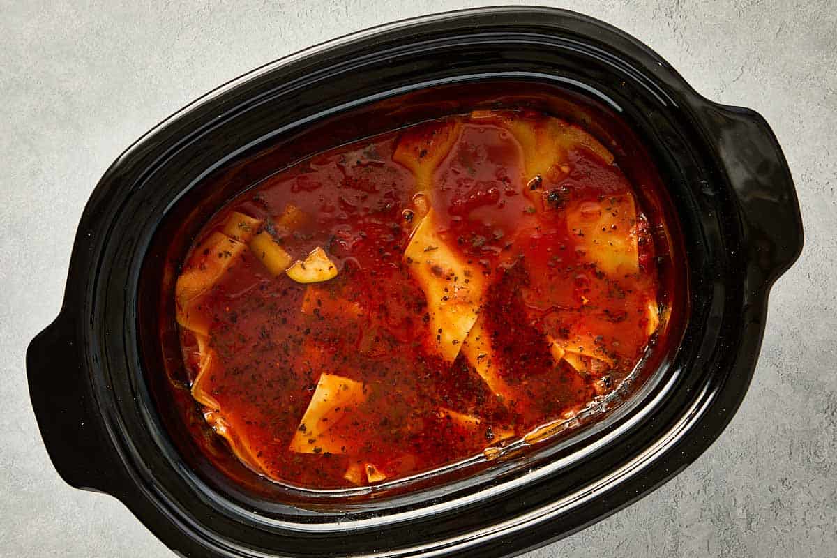 top overview of slowcooker filled with lasagna soup. - 12