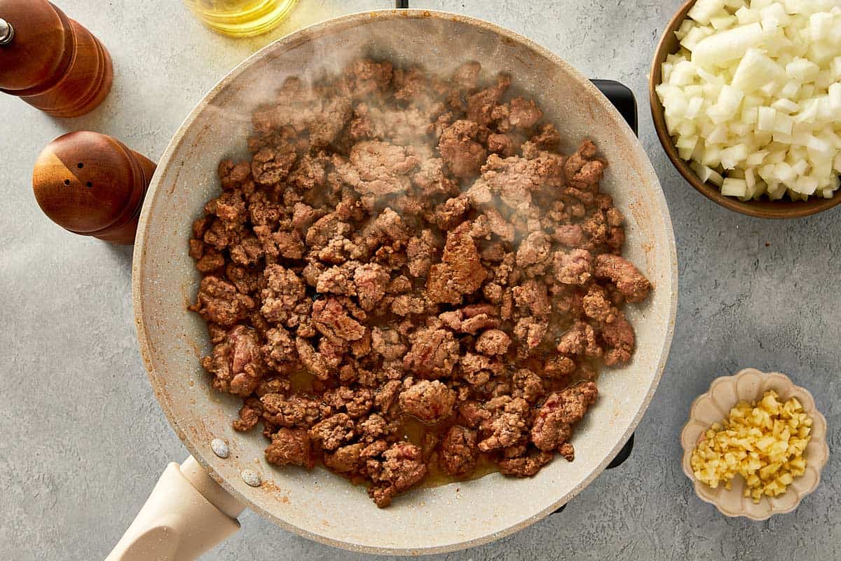 top overview of cooked beef in a beige pan - 5