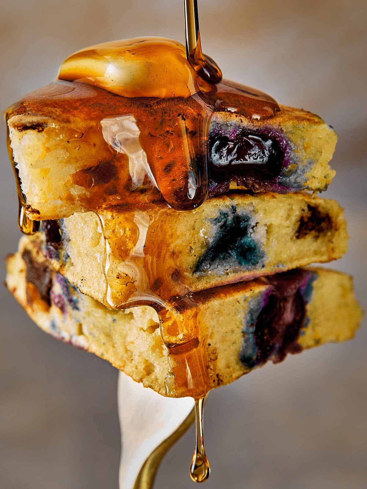Close Up Blueberry Pancakes being hold by a fork