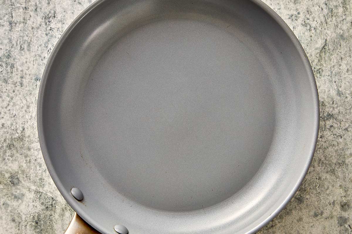 Top overview of empty pan in a grey surface