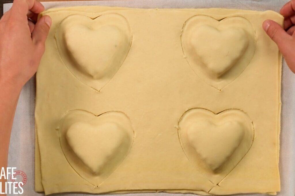top down view of 4 hearts being made and cut out