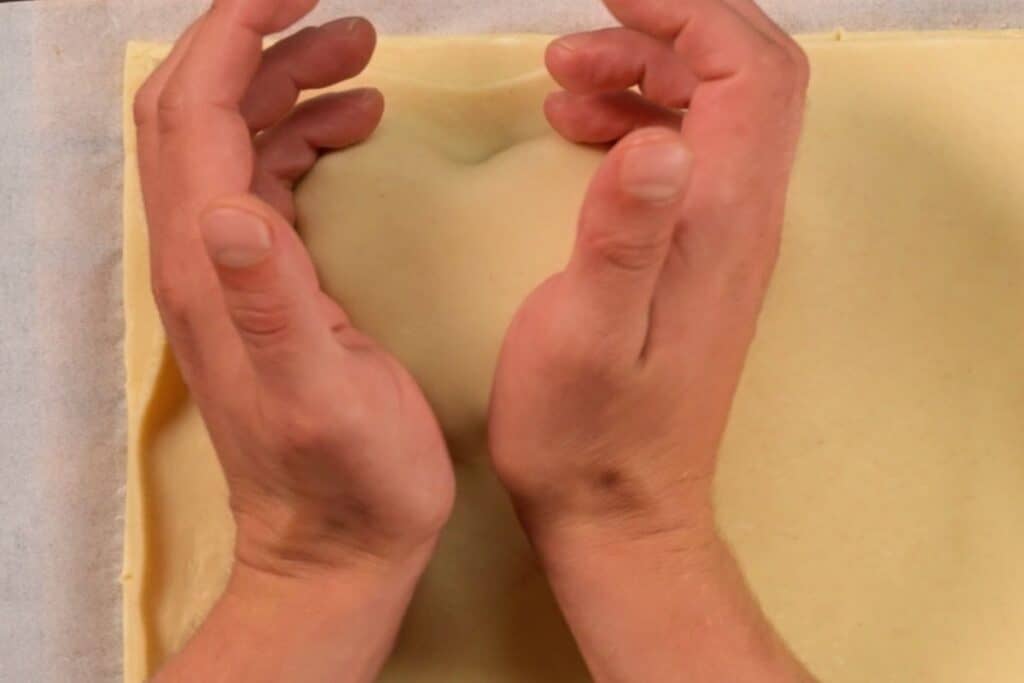 top down view of hearts being sealed by hand