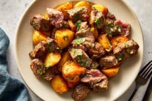 Served steak bites and potato in a bowl