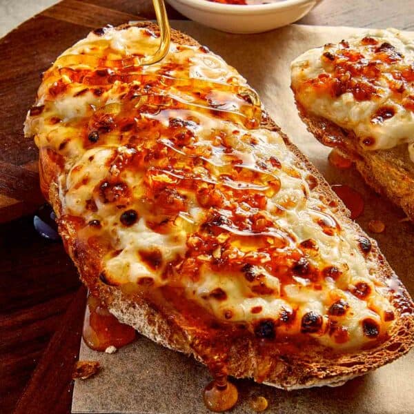 Close view of cottage toast with cottage cheese, crispy chilli oil and hot honey