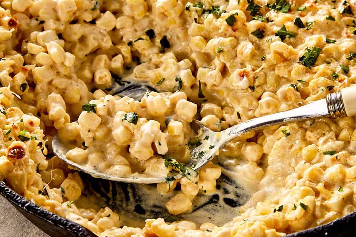 Creamy corn with melted parmesan and herbs, served warm and ready to enjoy