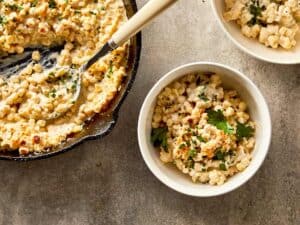 Creamy corn with melted parmesan and herbs, served warm and ready to enjoy