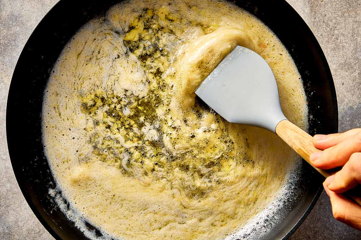 melting butter with garlic in pan for garlic parmesan sauce