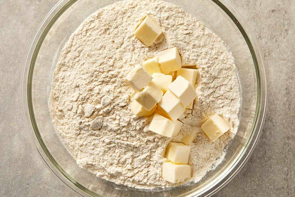 Flour and cubed butter in a mixing bowl ready to be combined
