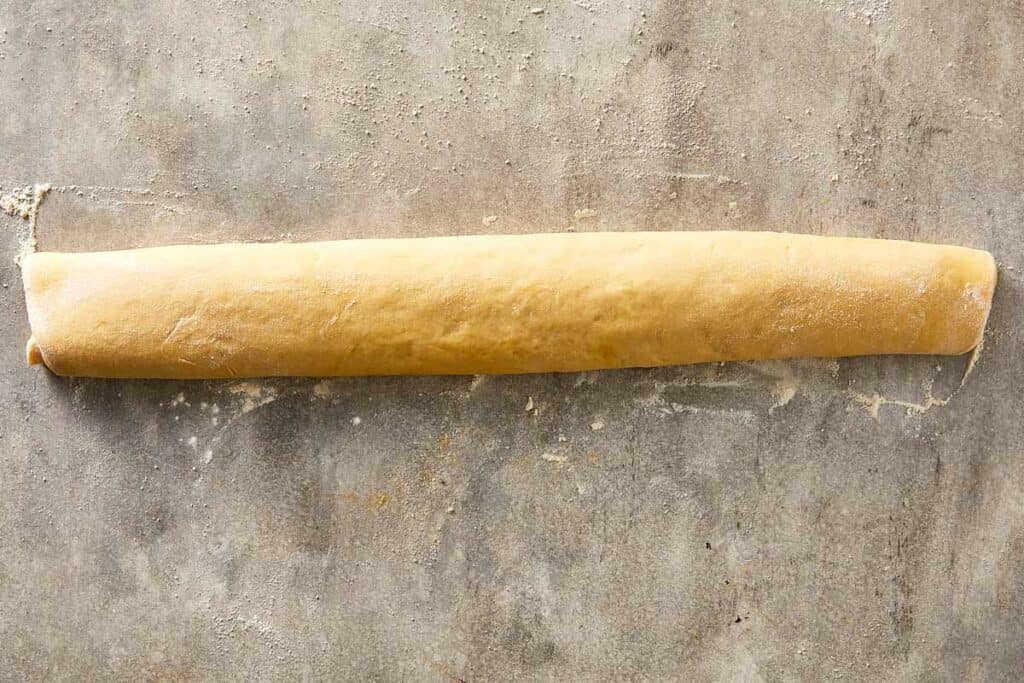 Dough rolled into a log with Nutella filling inside