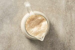 Foamy activated yeast mixture in a measuring jug