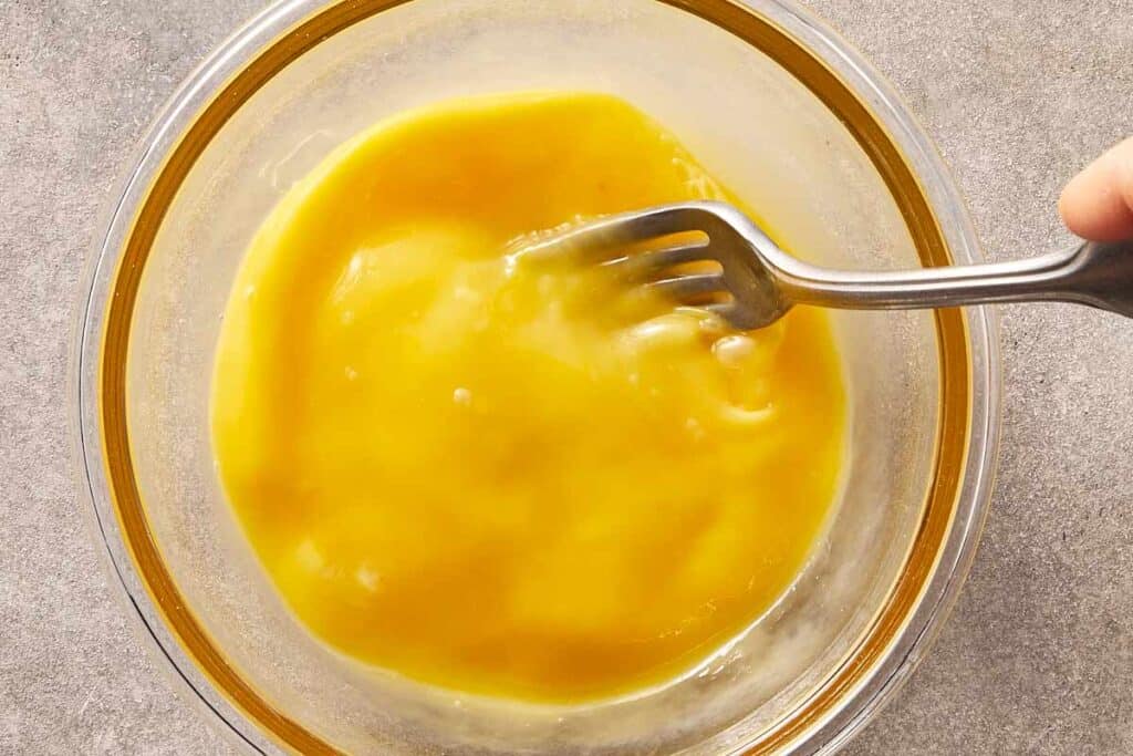 Eggs being beaten in a small bowl