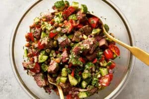tossed steak chickpea salad with chimichurri in a bowl