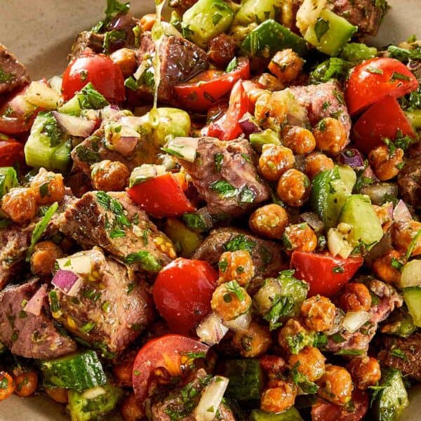 steak and chickpea salad with crispy roasted chickpeas tomatoes cucumber avocado and chimichurri