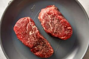 Top overview of raw beef in a skillet