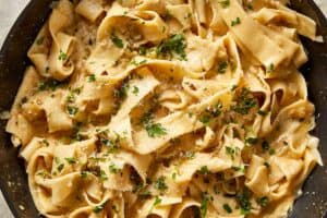 Brown butter Alfredo pasta finished with fresh parsley and grated parmesan, ready to serve.