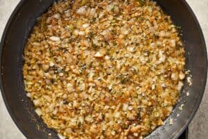 Shallots and garlic cooking in browned butter with herbs until soft and lightly golden.