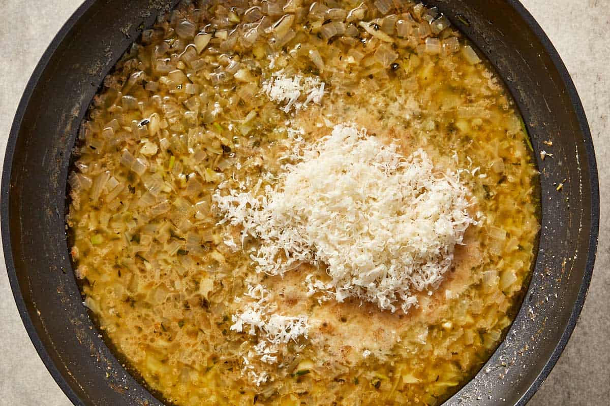 Grated parmesan added to the sauce with shallots and browned butter, melting into a creamy base.