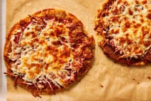 Baked chicken parm tacos with melted cheese on tray