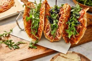 Chicken parm smashed tacos assembled with arugula