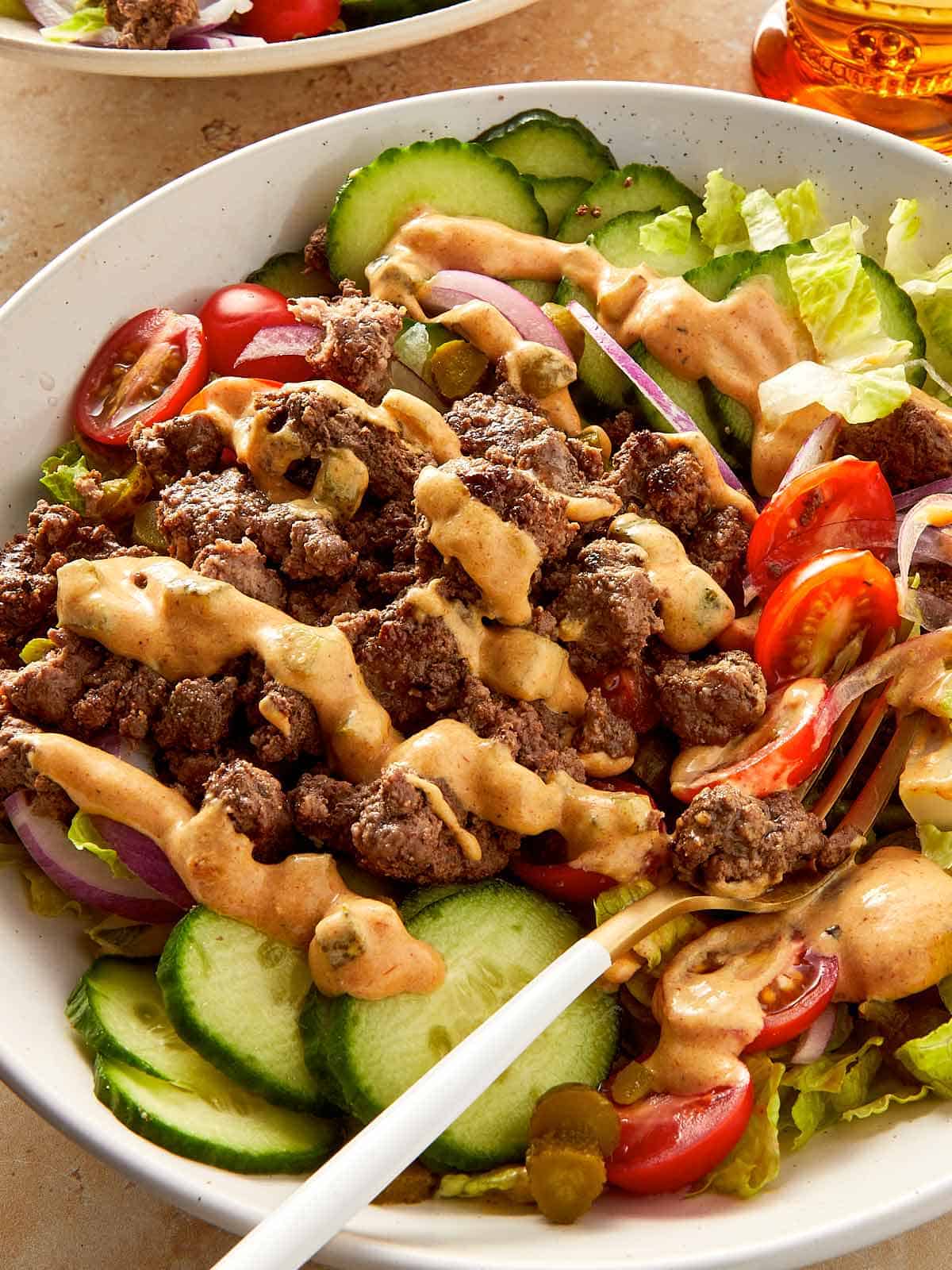 Close Up Burger Bowl with secret Sauce in a beige surface
