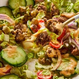 Close Up Burger Bowl with secret Sauce in a beige surface