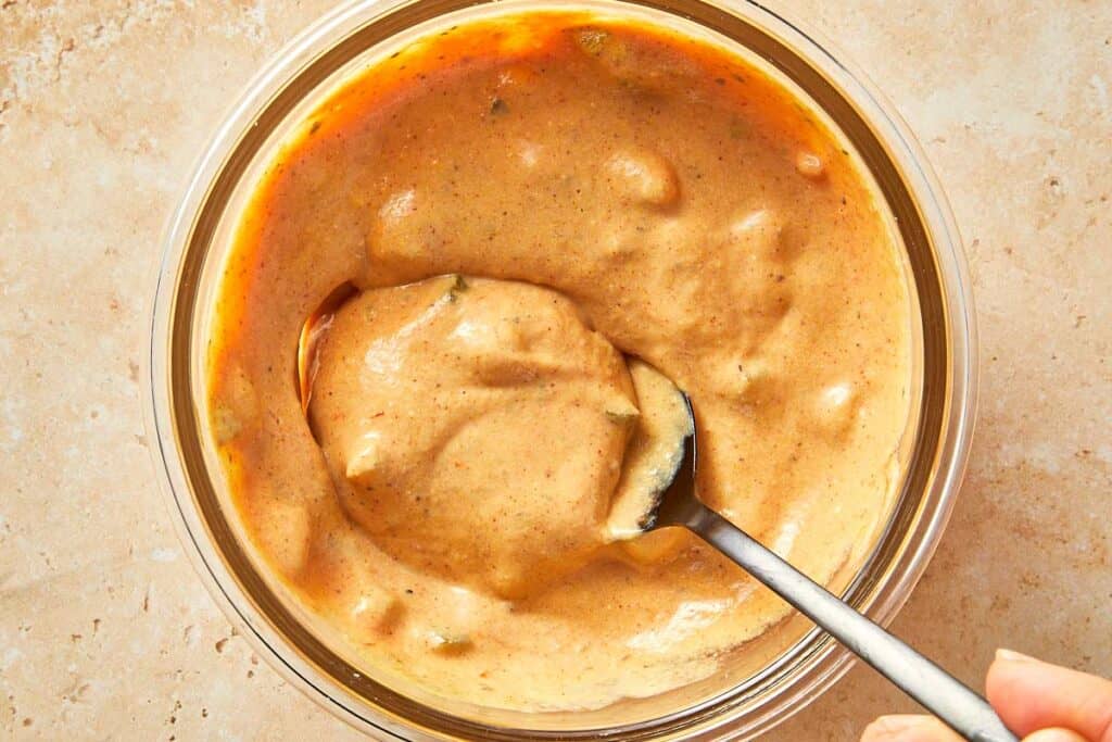 Creamy burger sauce made with yogurt, mustard, and ketchup mixed in a bowl.