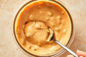 Creamy burger sauce made with yogurt, mustard, and ketchup mixed in a bowl.
