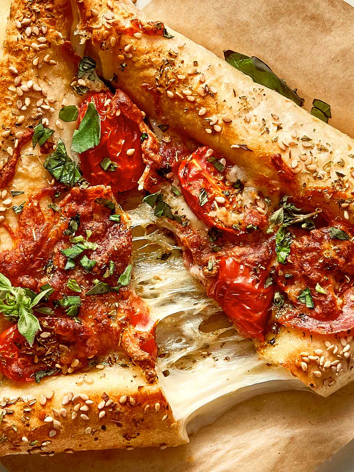 close up of cheese being pulled of an easy tortilla pizza 