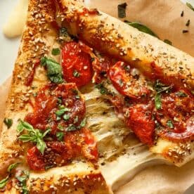 close up of cheese being pulled of an easy tortilla pizza