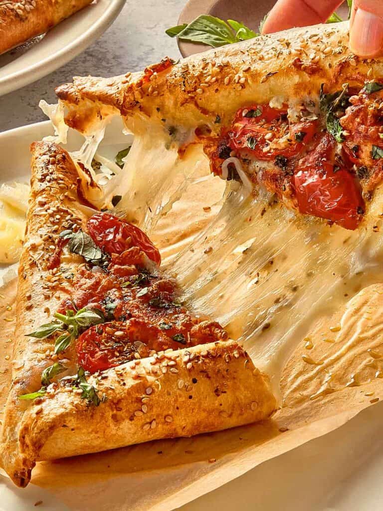 cheese being pulled of a tortilla pizza