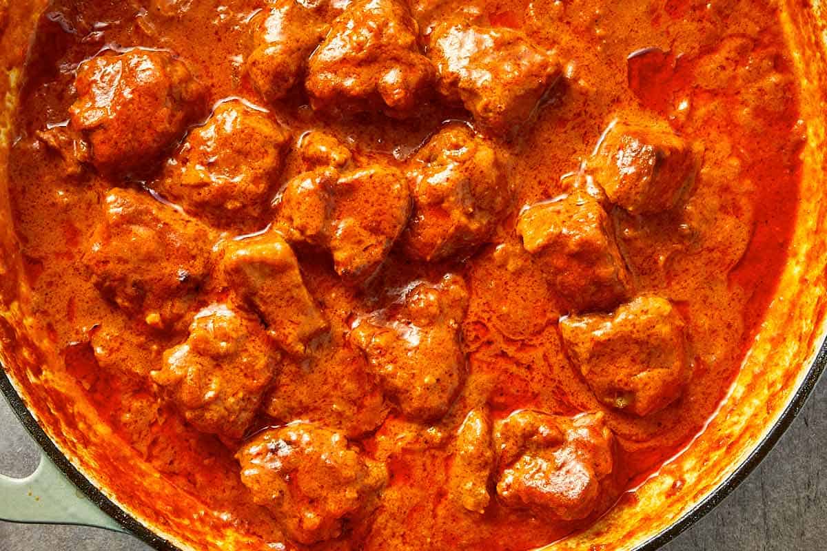 Thickened lamb curry with rich sauce coating the meat.