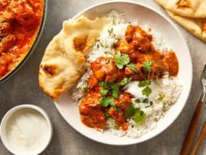 finished lamb curry dish served wit rice and naan