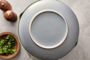 Plate placed over pan ready to flip tortilla española